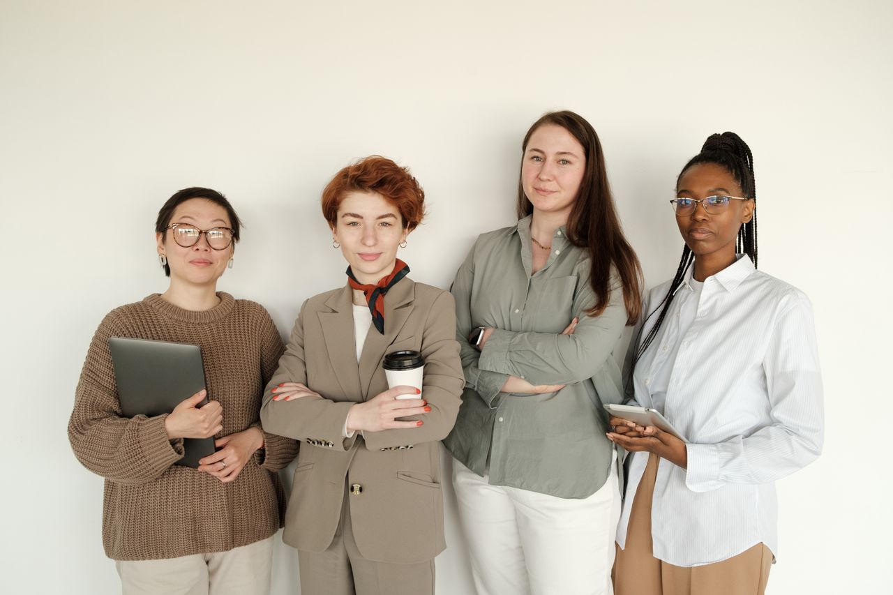 services-03 A group of confident businesswomen posing together in a professional setting, showcasing diversity and teamwork.